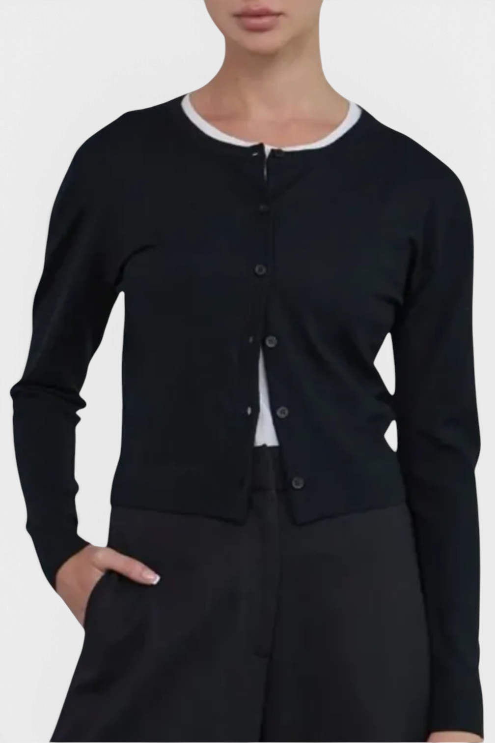 The Copper Shed Florence black cotton button-front cardigan with ribbed trims and shell buttons worn by a model.