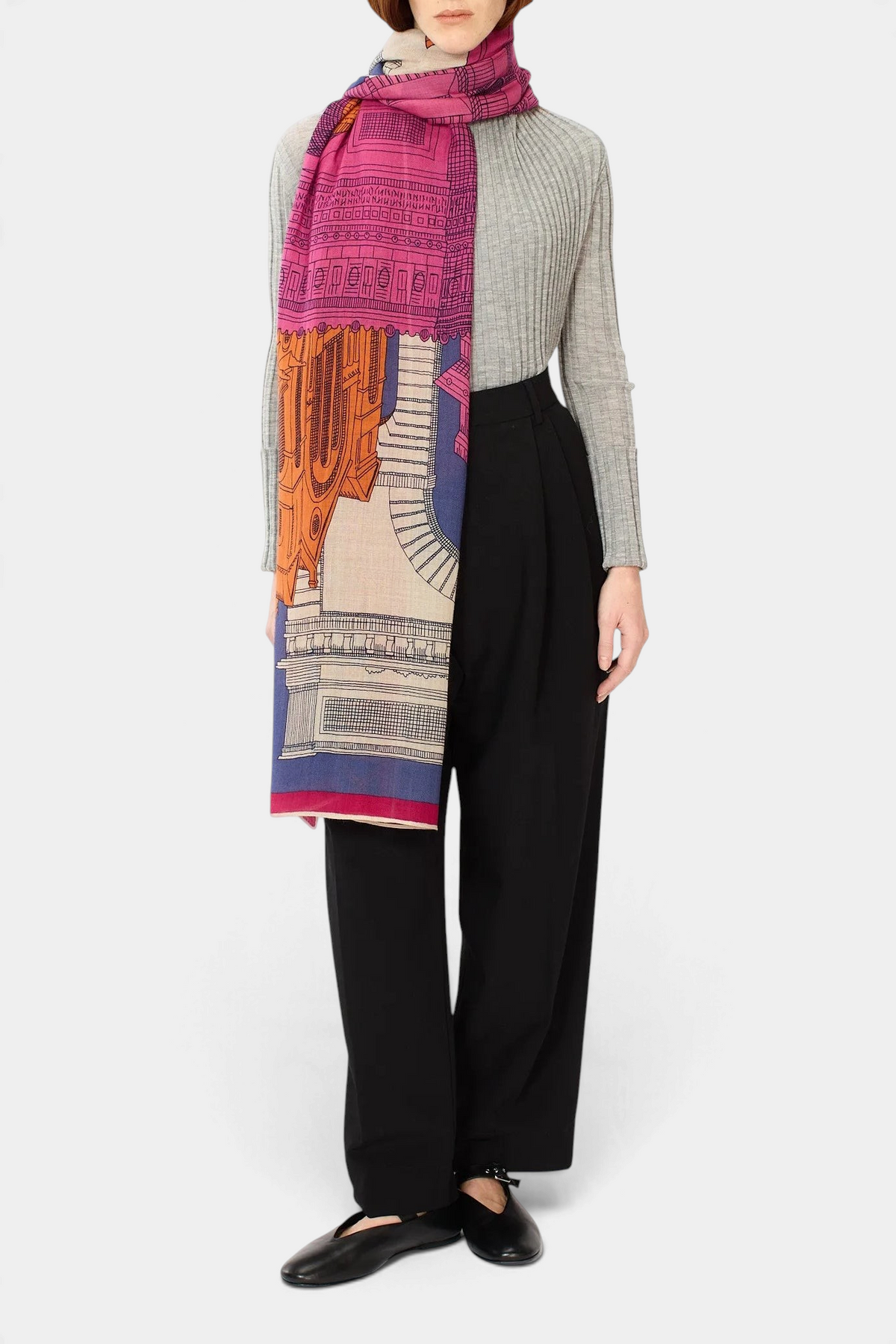 The Copper Shed fuchsia Paris print wool scarf draped over a model wearing a grey ribbed top and black trousers