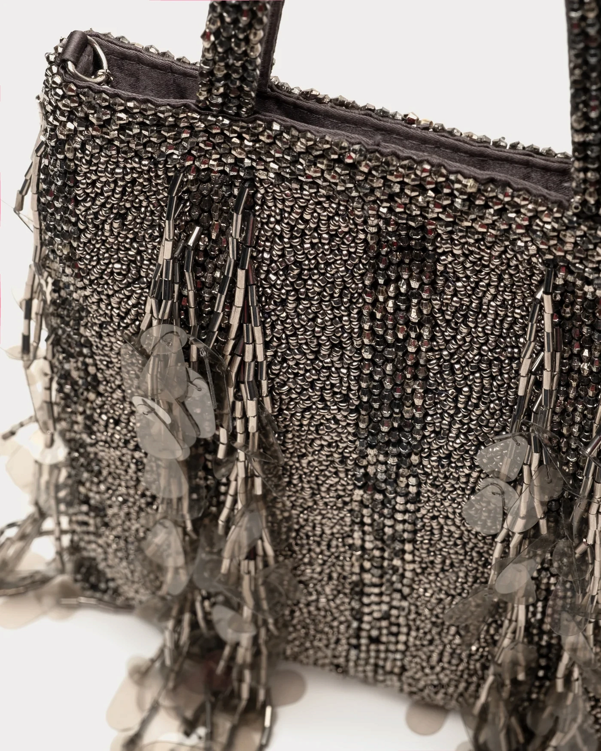 The Copper Shed Gatsby Mini Tote in metallic grey with intricate beadwork, sequins, and a chain strap.