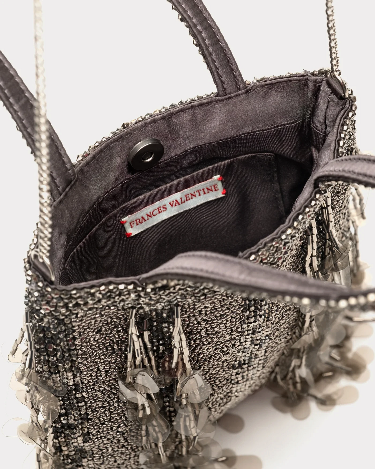 The Copper Shed Frances Valentine Gatsby mini tote featuring grey sequins, beads, and a silver chain strap.