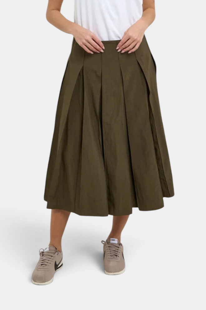 The Copper Shed Gemma midi pleated skirt in olive green sandwashed rayon and cotton blend with a side zip closure.