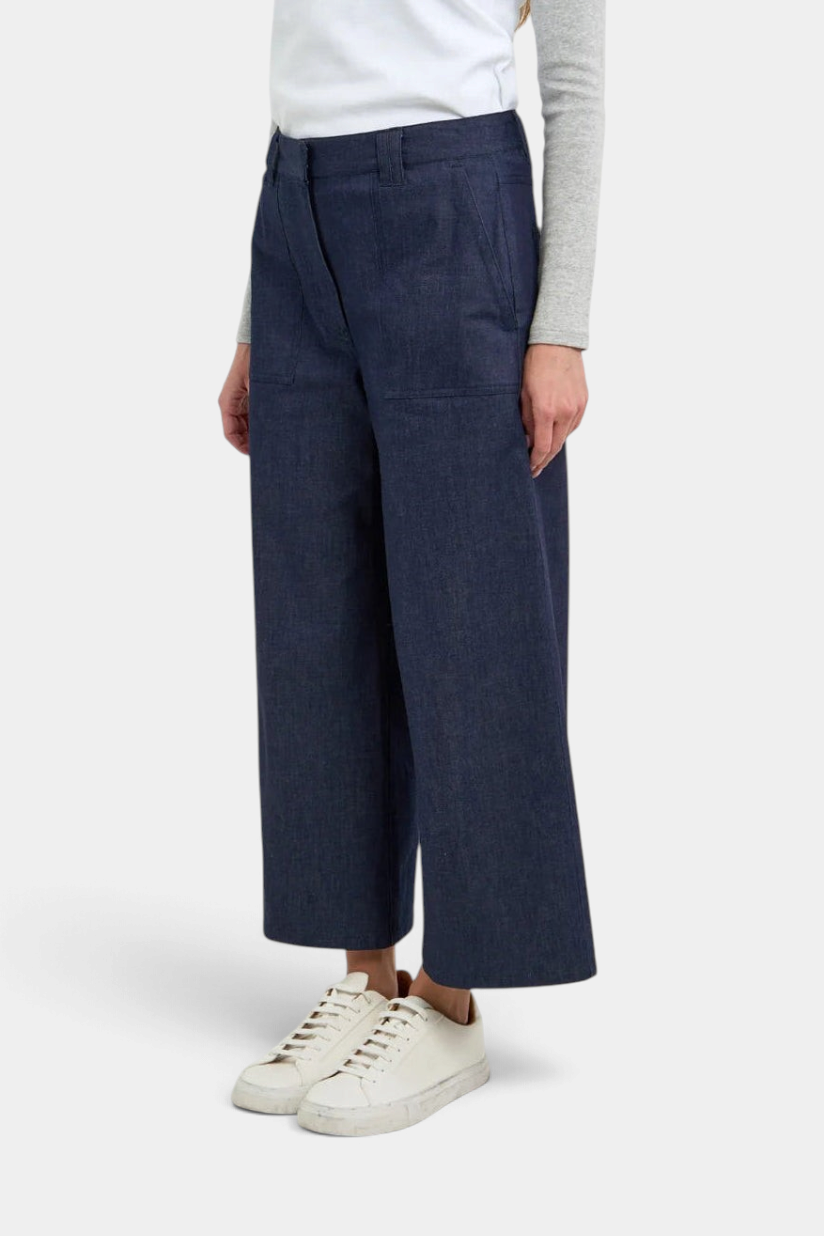 The Copper Shed Gerri Pant in dark blue denim with contrast luggage-colored topstitching and wide-leg silhouette.