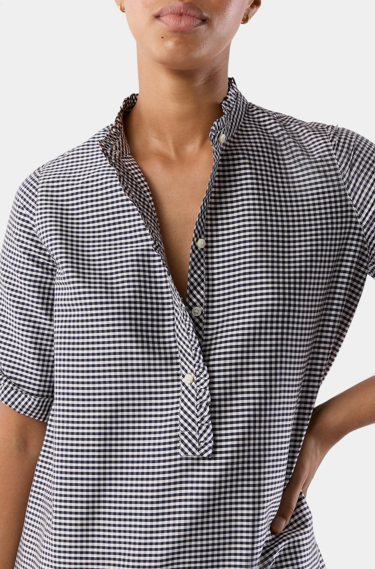 The Copper Shed black and white gingham popover dress with frilled collar and button placket on a model