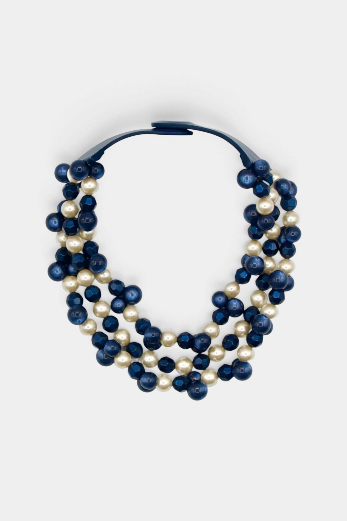The Copper Shed Gisella navy and cream layered resin bead necklace on a leather collar with magnetic closure.