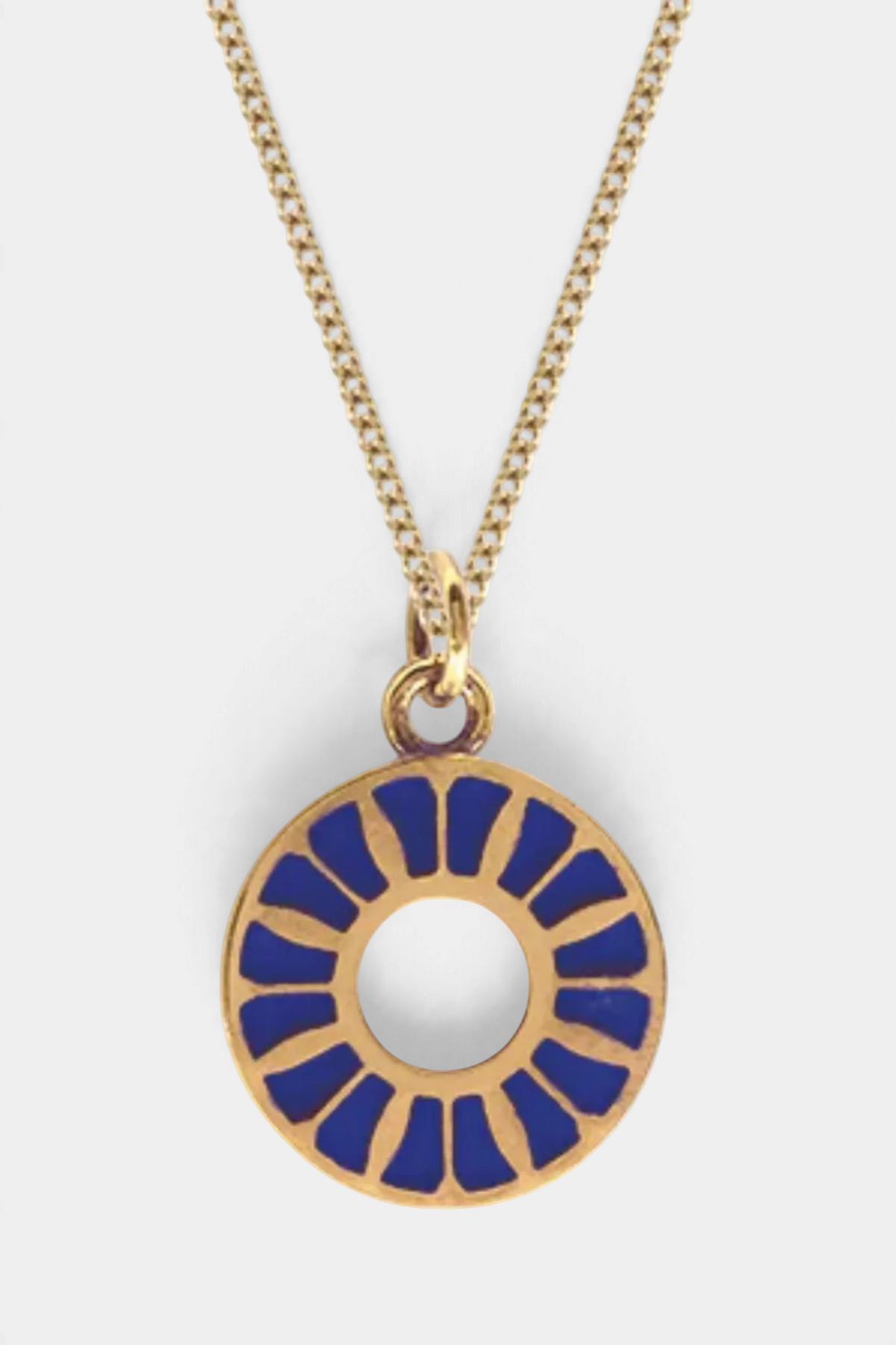 The Copper Shed gold vermeil necklace featuring a circular pendant with blue enamel flower petal detailing.