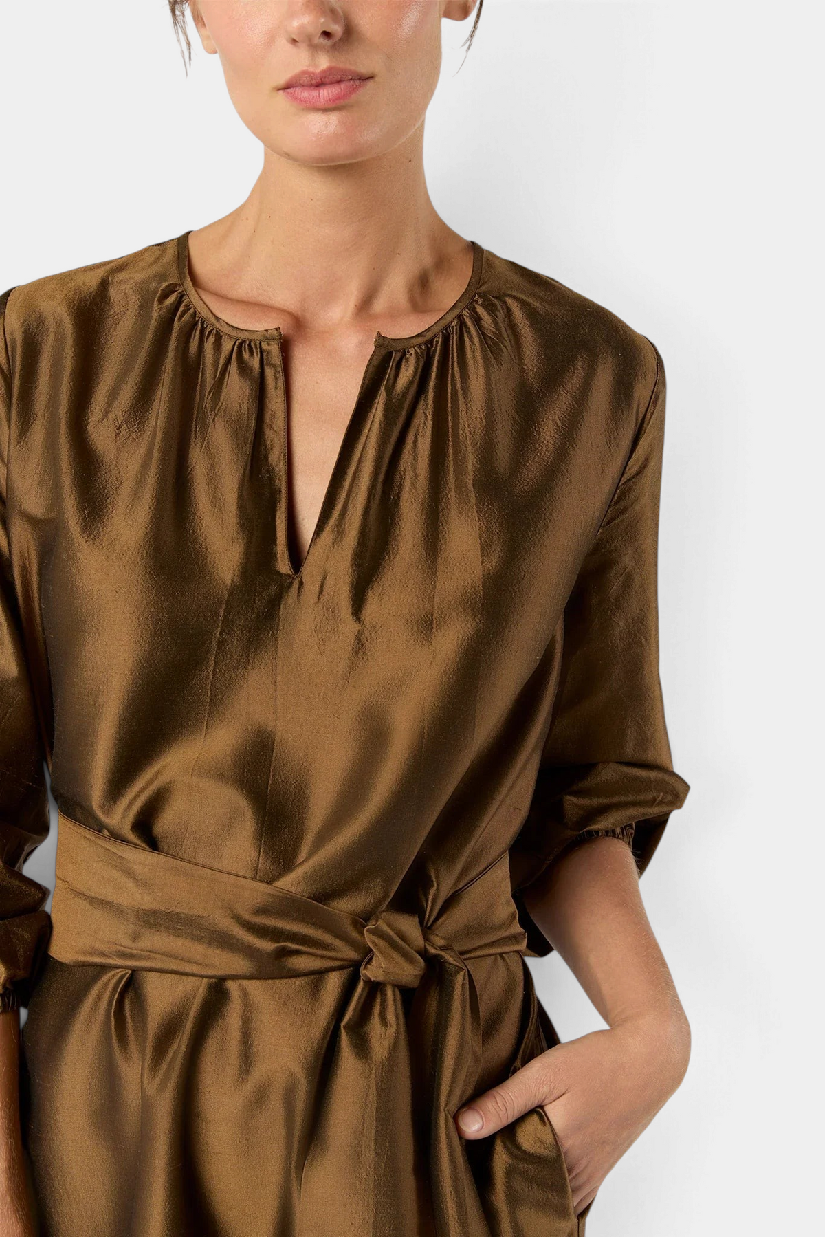 The Copper Shed gold silk shantung maxi dress with an open neckline, elastic cuffs, and a self-tie belt.