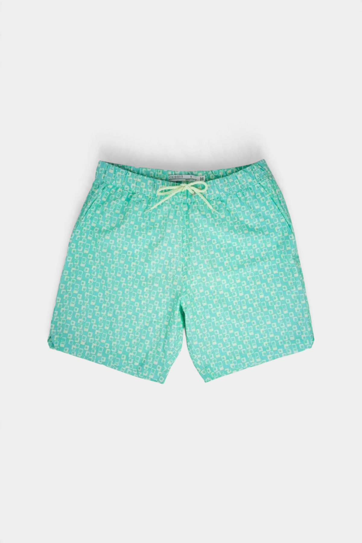 The Copper Shed swim trunks in light green with a white geometric square pattern, elastic waist, and drawstring.