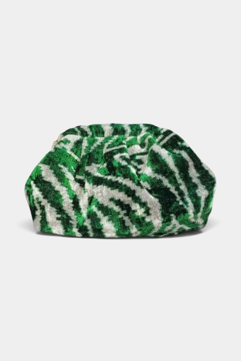 The Copper Shed handmade green and white silk velvet ikat dumpling clutch with a soft pleated silhouette.