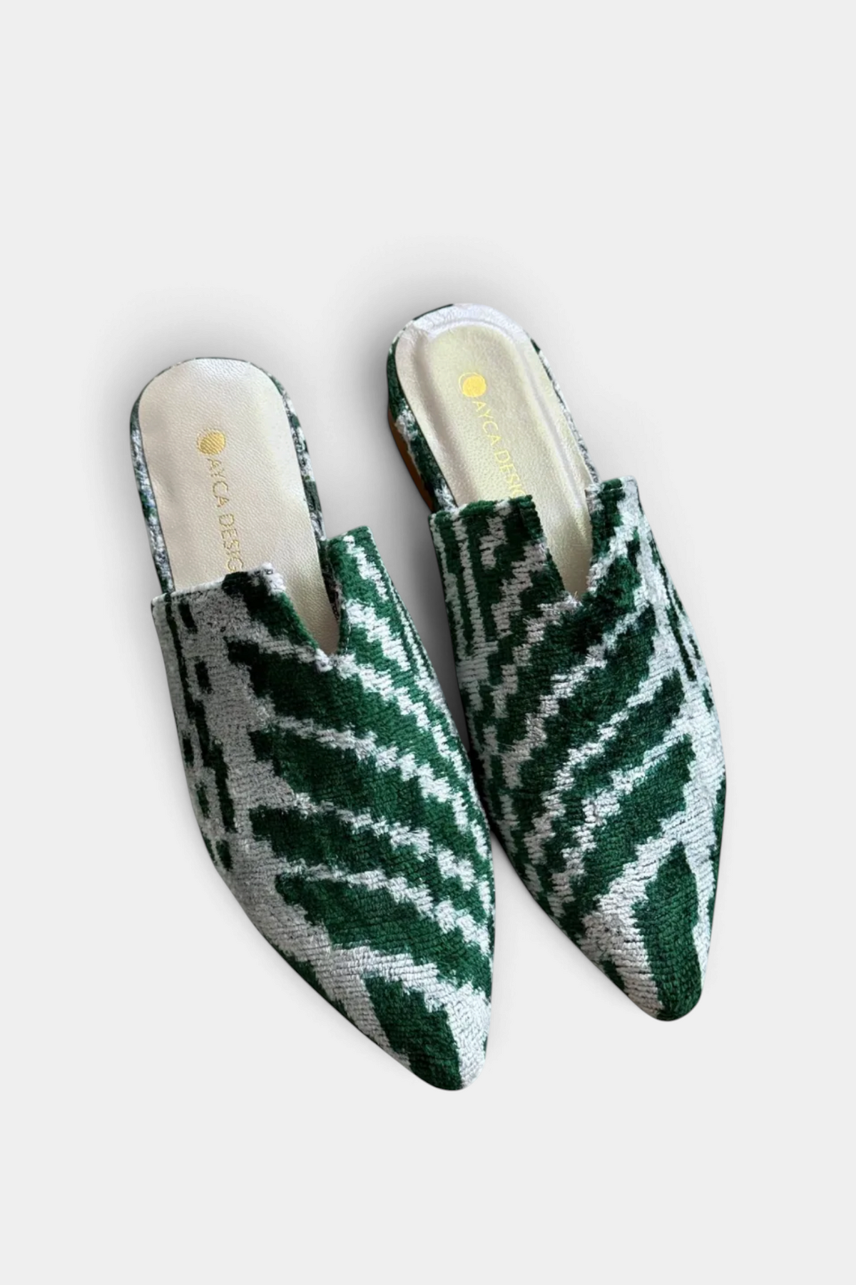 The Copper Shed green and white silk velvet ikat pointed-toe slide slippers with leather lining