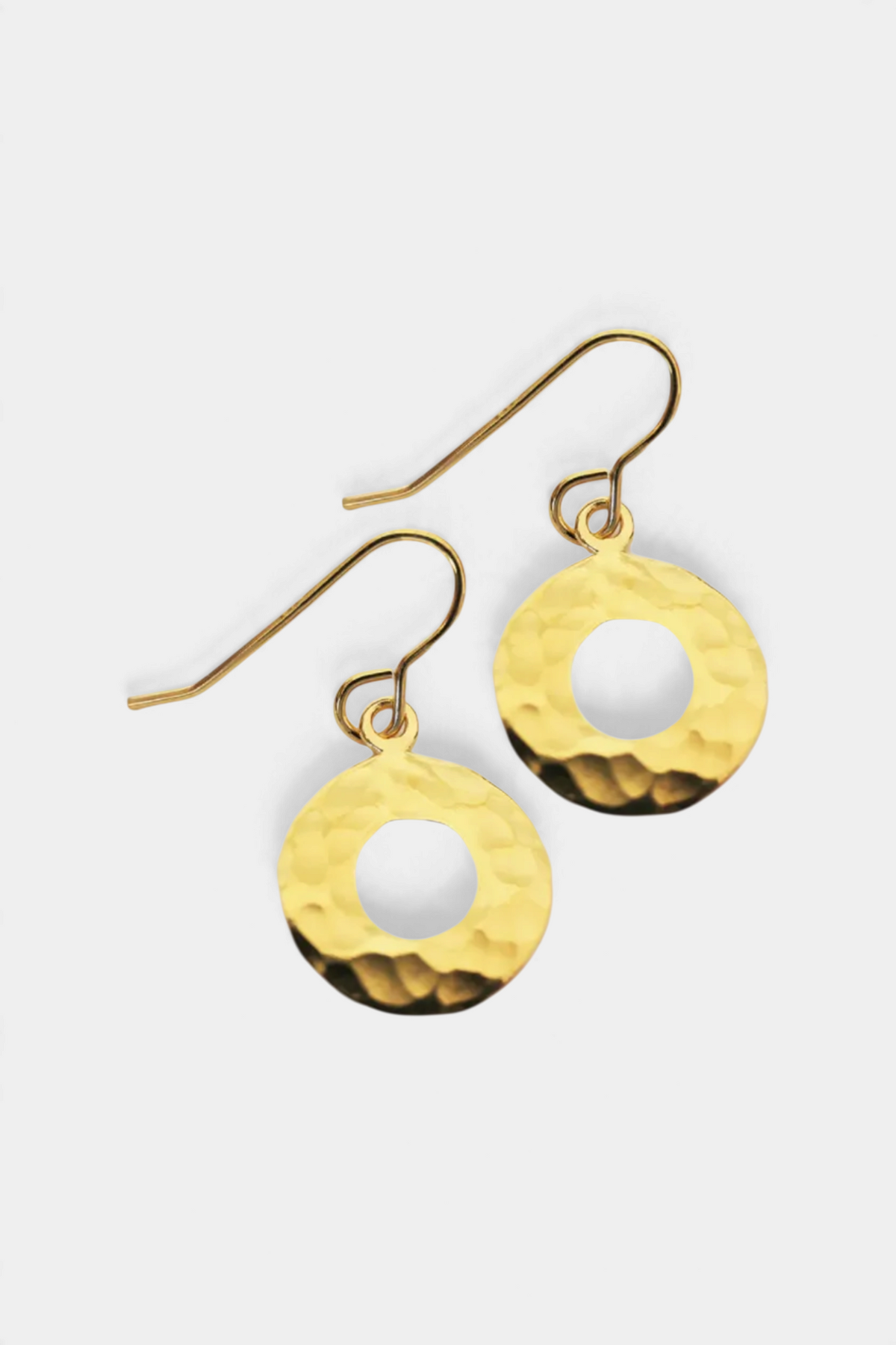 The Copper Shed gold-tone hammered disc earring hooks with a circular cutout design on a plain background.