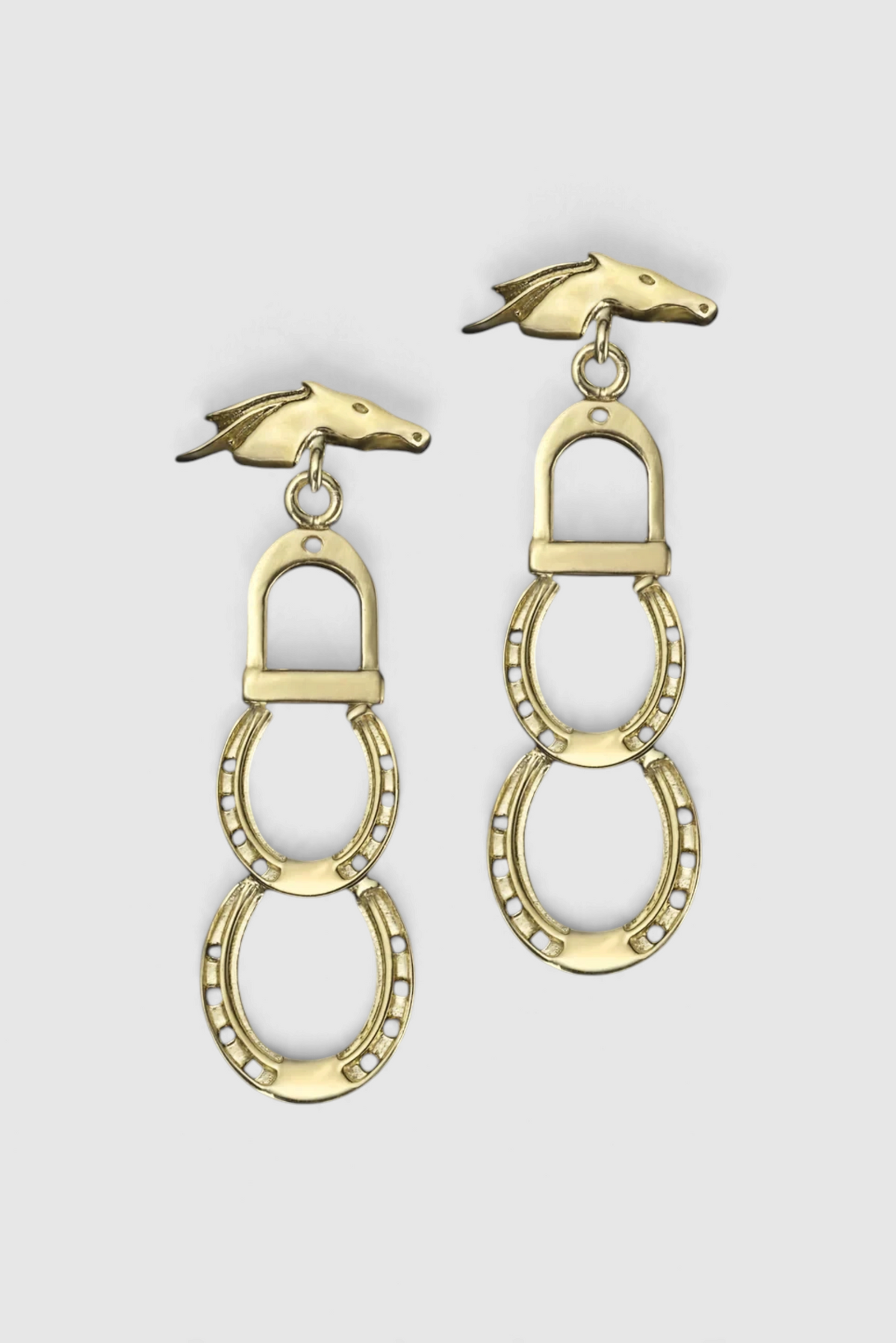 The Copper Shed Casa Libertas handmade gold-tone drop earrings featuring horse head and horseshoe equestrian motifs.