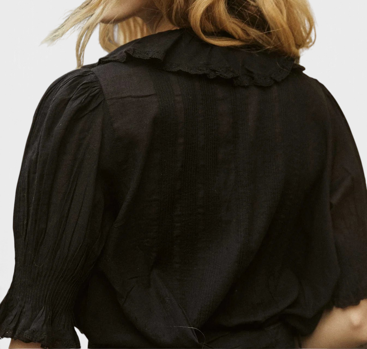 The Copper Shed Henri top in black organic cotton voile featuring a ruffled collar and pintuck details on the back.