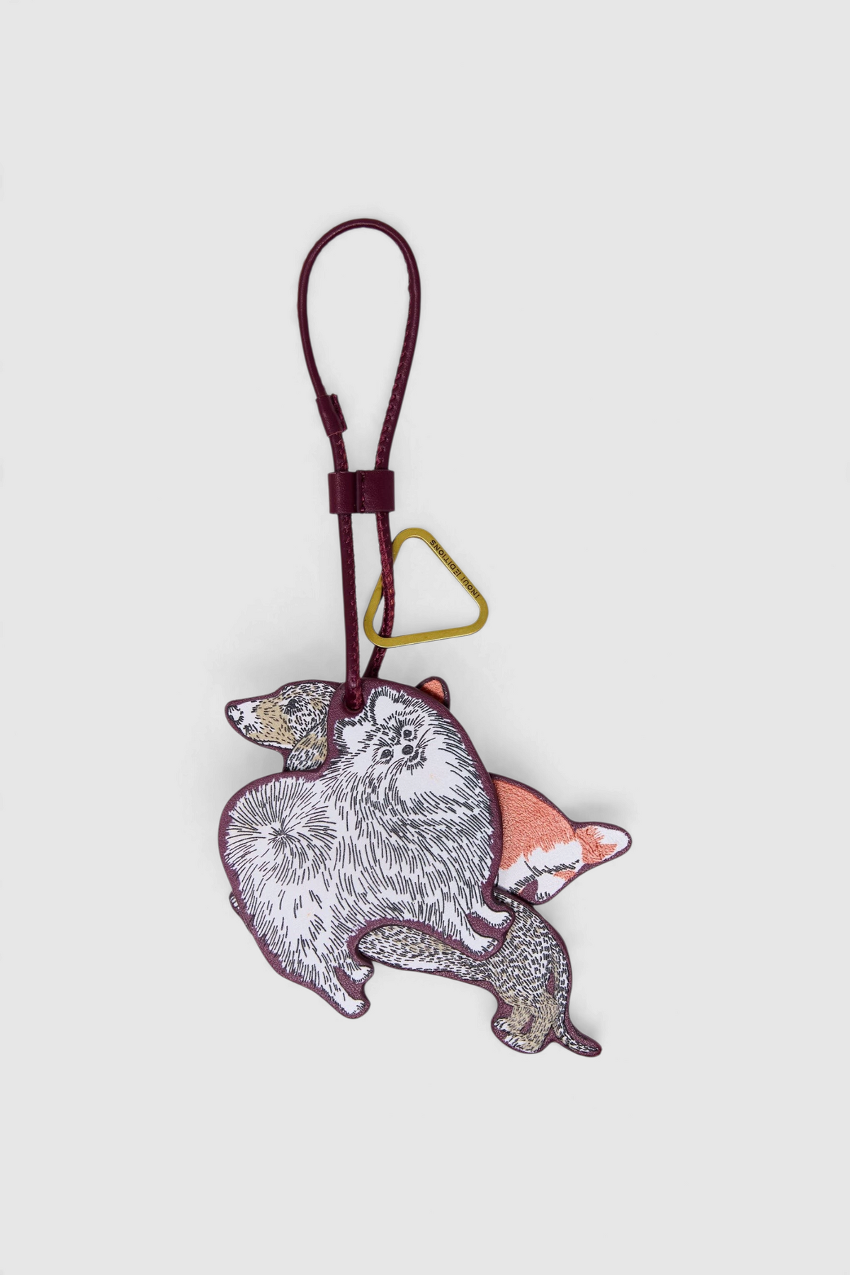 The Copper Shed Inoui Editions Toutou keychain featuring a colorful dog illustration on 100% Italian leather.