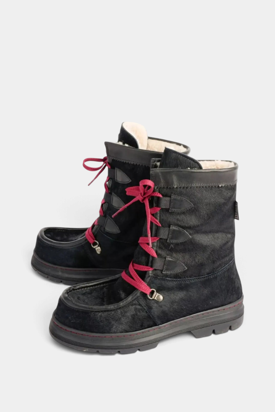 The Copper Shed Intrepid Pony Boot in black cowhide with shearling lining, sturdy rubber sole, and red laces.