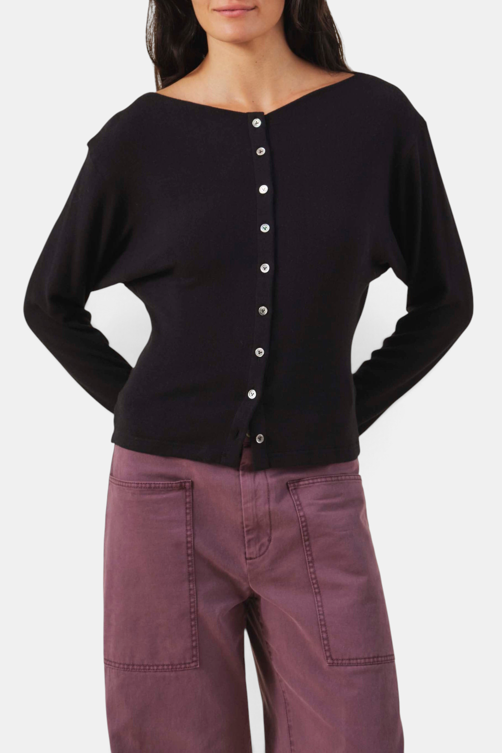 The Copper Shed Jordan black fine-gauge knit cardigan with a round neckline, button front, and thumbhole cuffs.