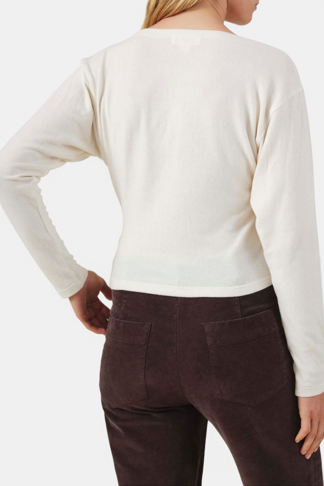Back view of The Copper Shed Jordan cream fine-gauge knit cardigan with long sleeves and fitted silhouette.