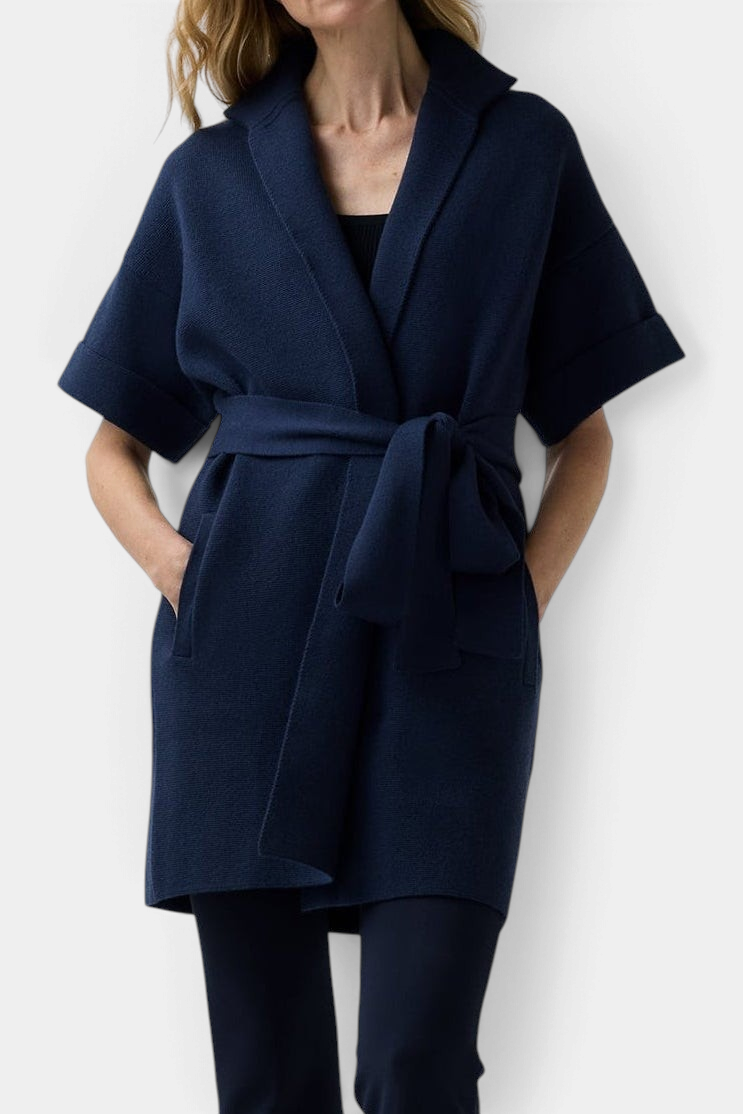The Copper Shed Julia cardigan in navy merino wool with short sleeves, stand collar, and a removable waist belt.