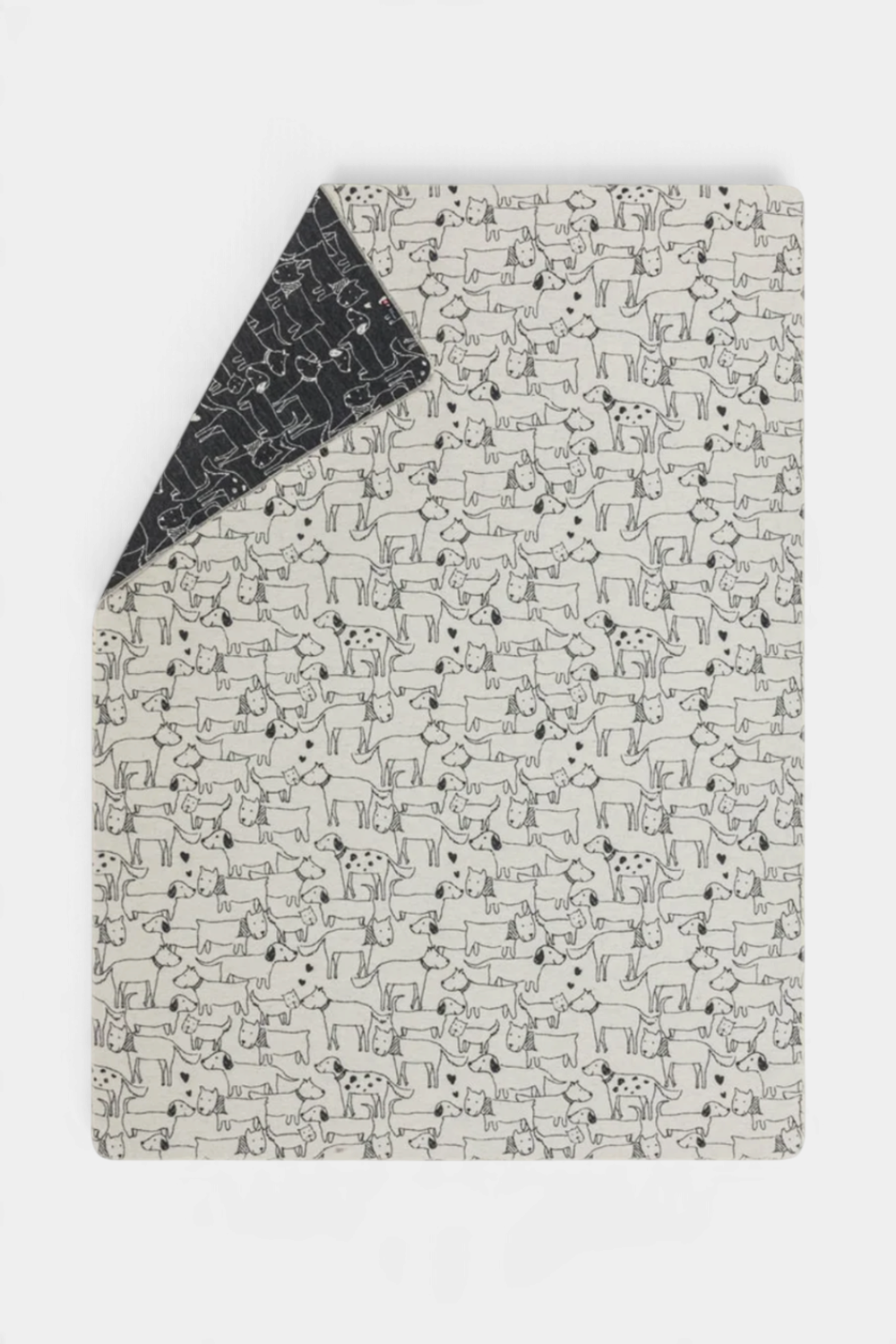 The Copper Shed JUWEL reversible cotton throw blanket featuring a black and white dog pattern for children.