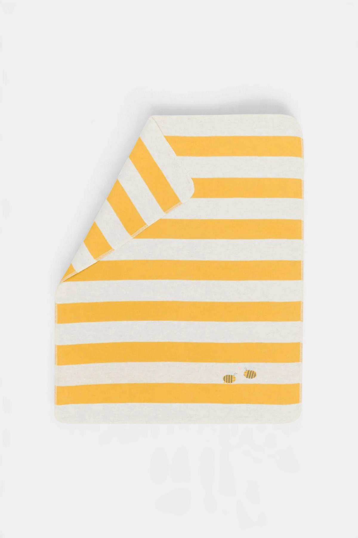The Copper Shed JUWEL baby blanket in yellow and white stripes with embroidered bee details, made from soft cotton.