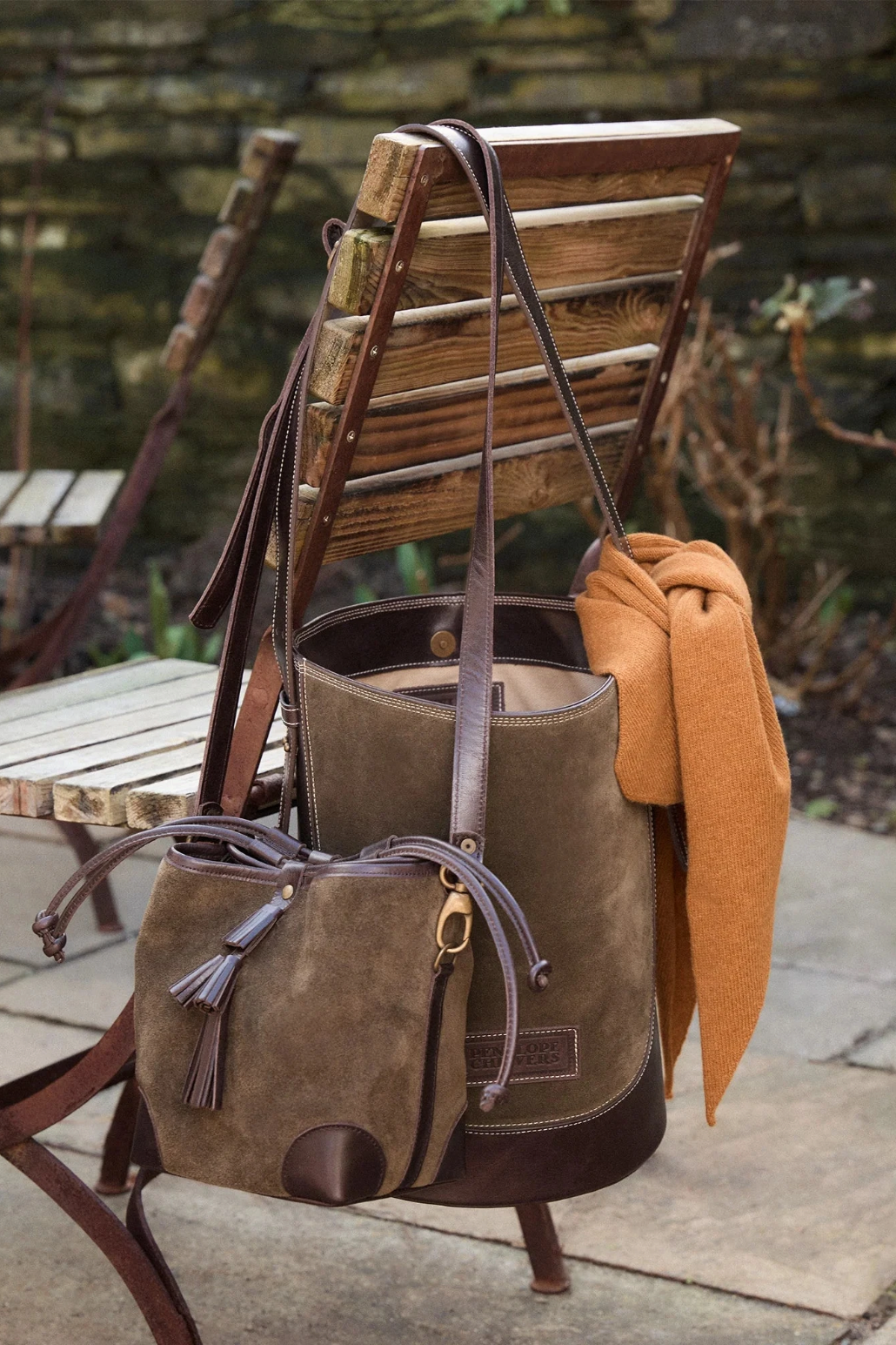 The Copper Shed khaki suede fortune teller crossbody bag with chocolate leather trim and tiered tassel detail.