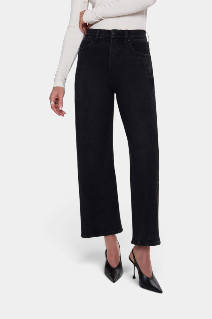 The Copper Shed Kyra high rise jeans in black comfort stretch denim with a bowed leg silhouette and cropped ankle.