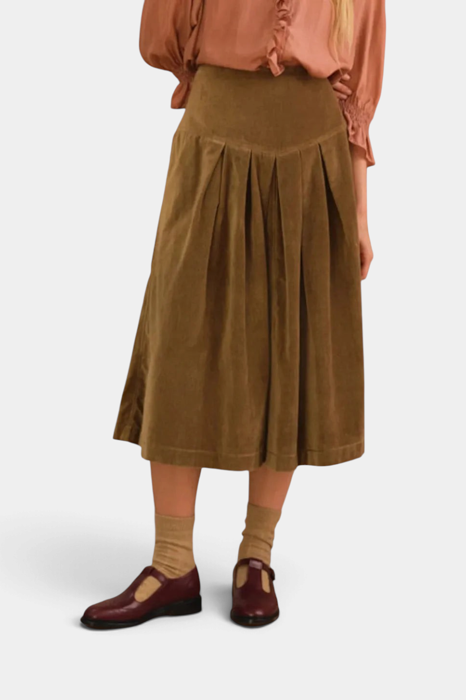 The Copper Shed Lancaster skirt in brown cotton velvet with a pleated waist and structured midi silhouette