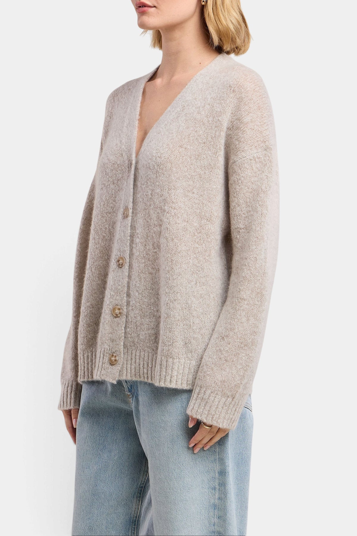 The Copper Shed Lea wool-cashmere cardigan in beige with a button-front, drop shoulders, and ribbed trim details.