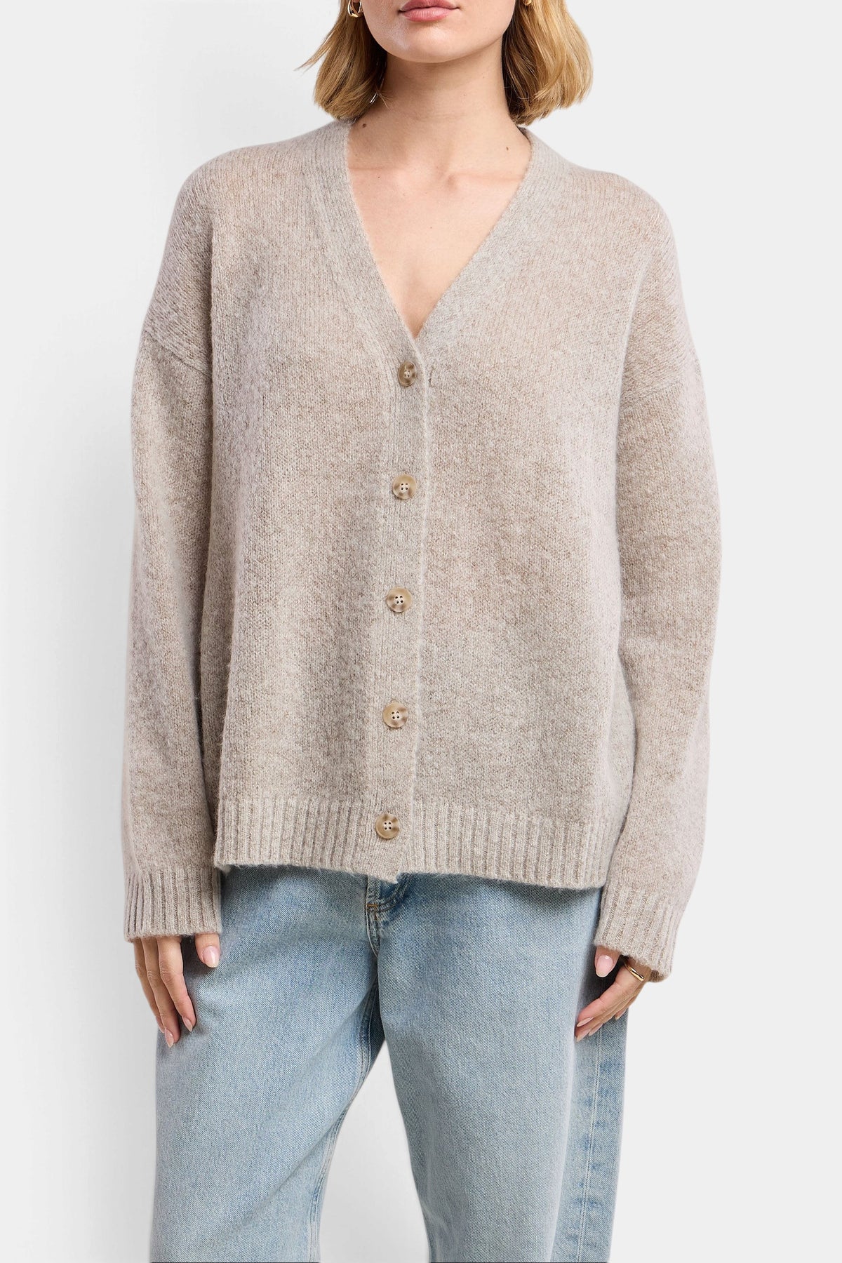 The Copper Shed Lea wool-cashmere cardigan in beige with button front, drop shoulders, and ribbed trim details.