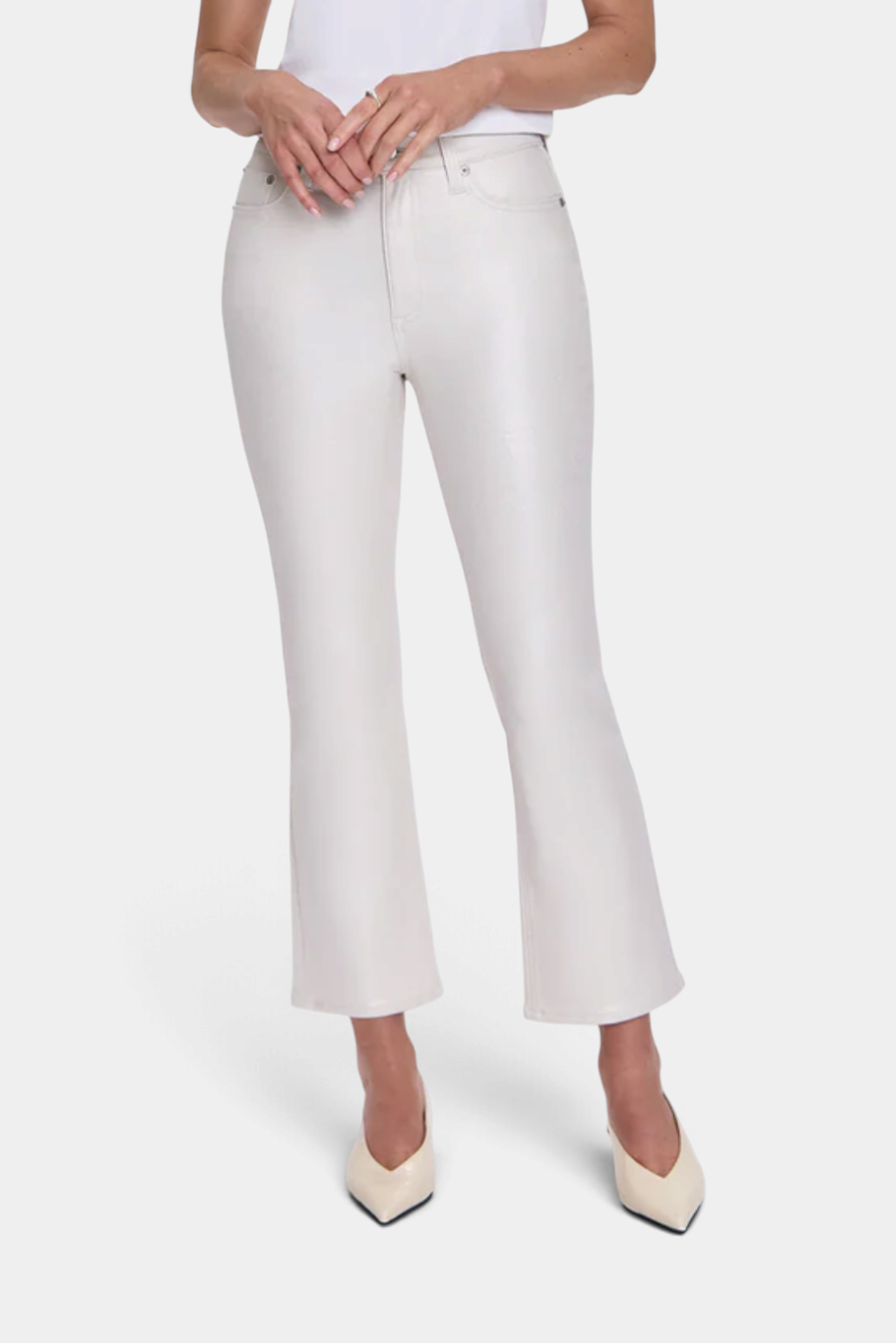 The Copper Shed Lennon high rise cream boot cut cropped denim jeans worn by a model with pointed heels