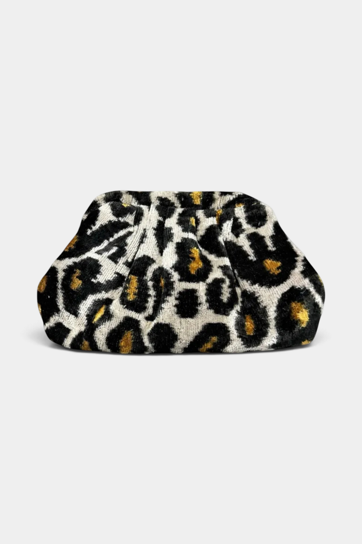 The Copper Shed handmade silk velvet ikat dumpling clutch in a black, white, and gold leopard print pattern.