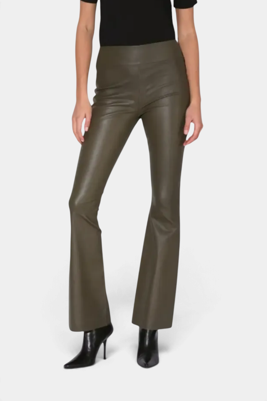 The Copper Shed Lexie olive green stretch leather flared pants with a mid-rise elastic waistband on a model.