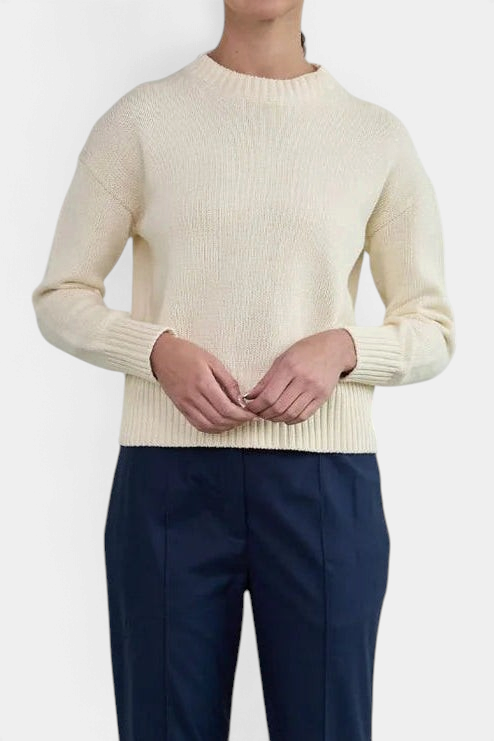 The Copper Shed Logan crewneck sweater in cream chunky cotton with a high-low hem and ribbed cuffs on a model.