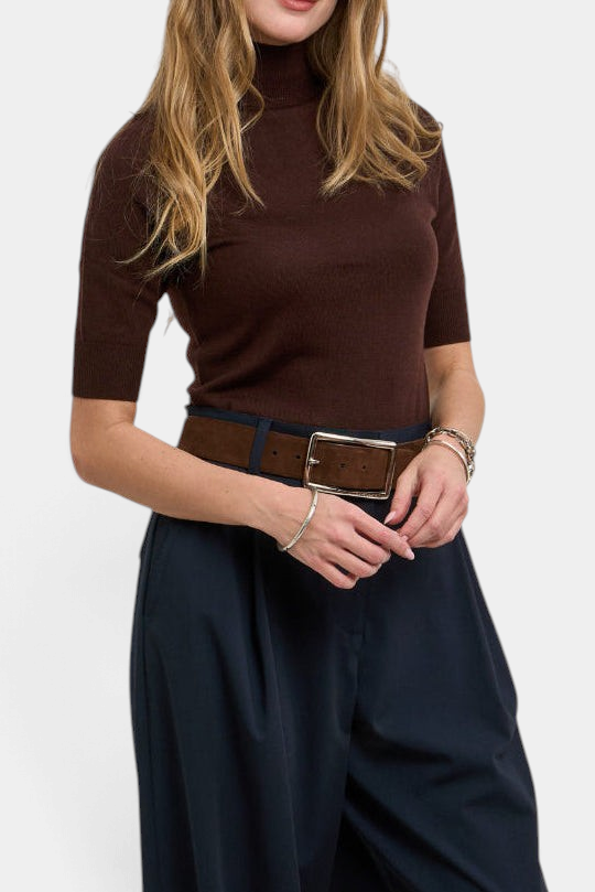 The Copper Shed Maddy sweater in brown merino wool with a mock neck and short sleeves, styled with a wide belt.