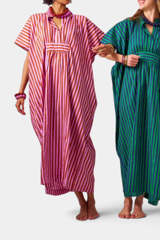 Two models wearing The Copper Shed Margot Stripe Kaftans in rusty brown and lilac, and green and blue striped patterns.