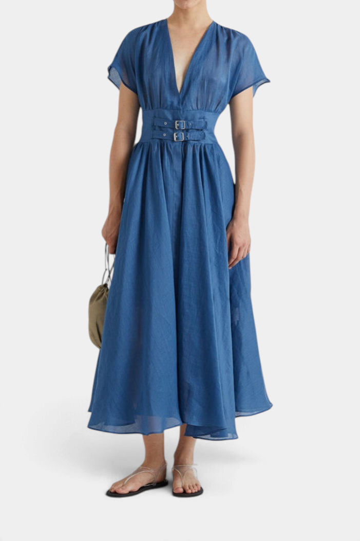 The Copper Shed MeiMeiJ blue flared midi dress with v-neck, buckled waist straps, and cap sleeves on a model