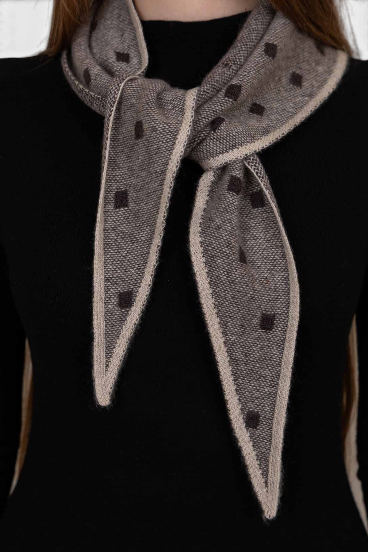 The Copper Shed Mia triangle neckerchief in taupe cashmere with a subtle dark brown square pattern and contrast trim.
