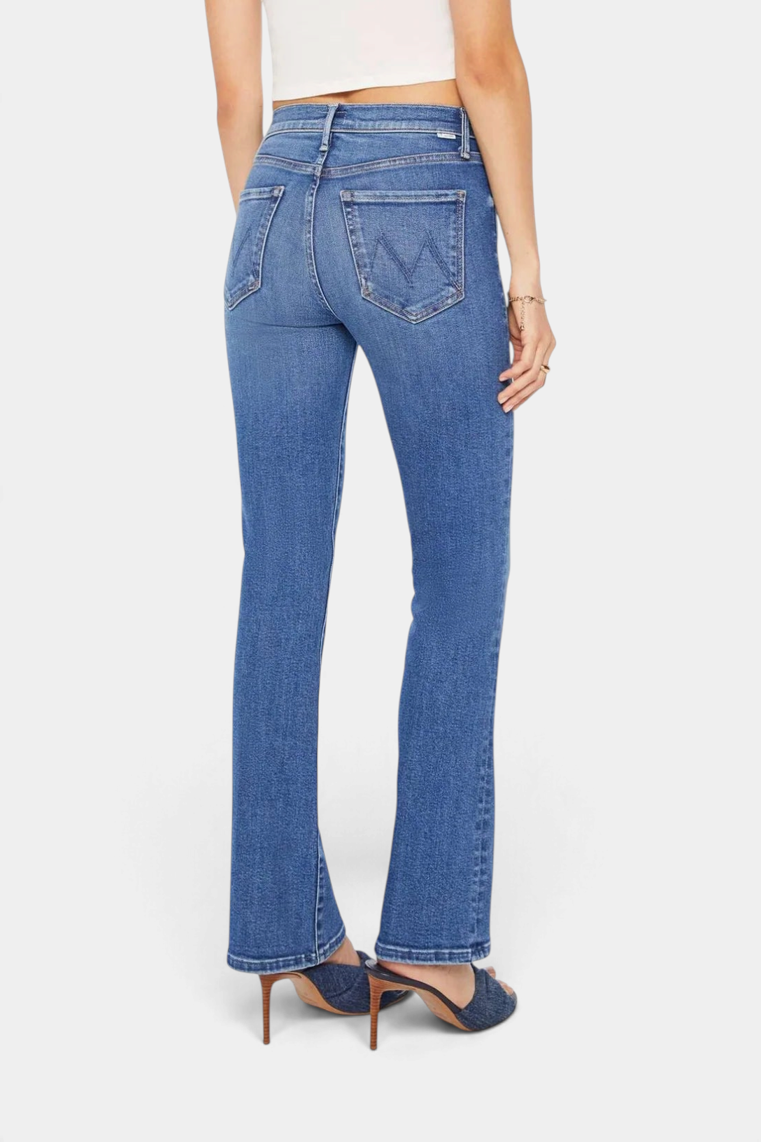 The Copper Shed The Outsider Skimp mid-blue stretch denim flare jeans with a clean hem, back view.