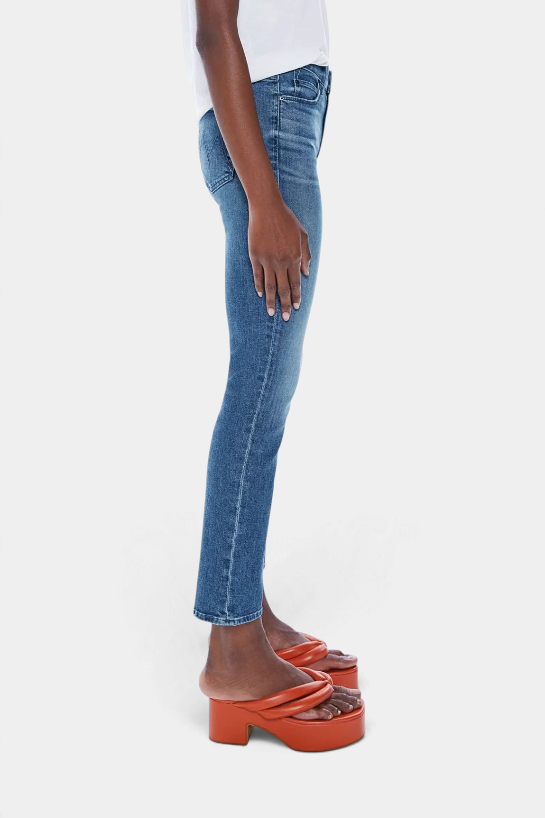 The Copper Shed Mid Rise Dazzler Ankle jeans in blue denim with a straight leg and frayed hem, side profile view.
