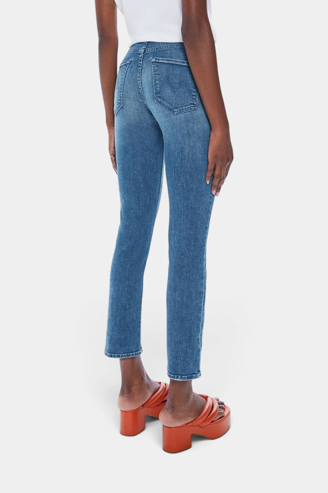 The Copper Shed Mid Rise Dazzler Ankle jeans in blue denim with a straight leg and frayed hem, back view