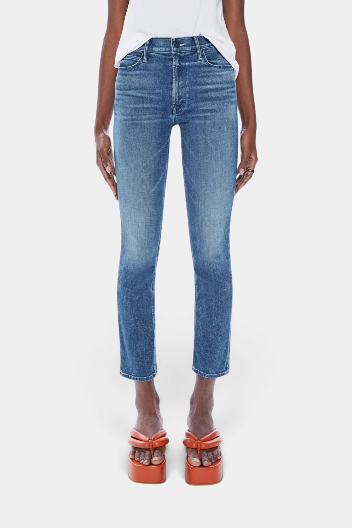 The Copper Shed Mid Rise Dazzler Ankle jeans in blue denim with a straight leg and frayed hem on a model