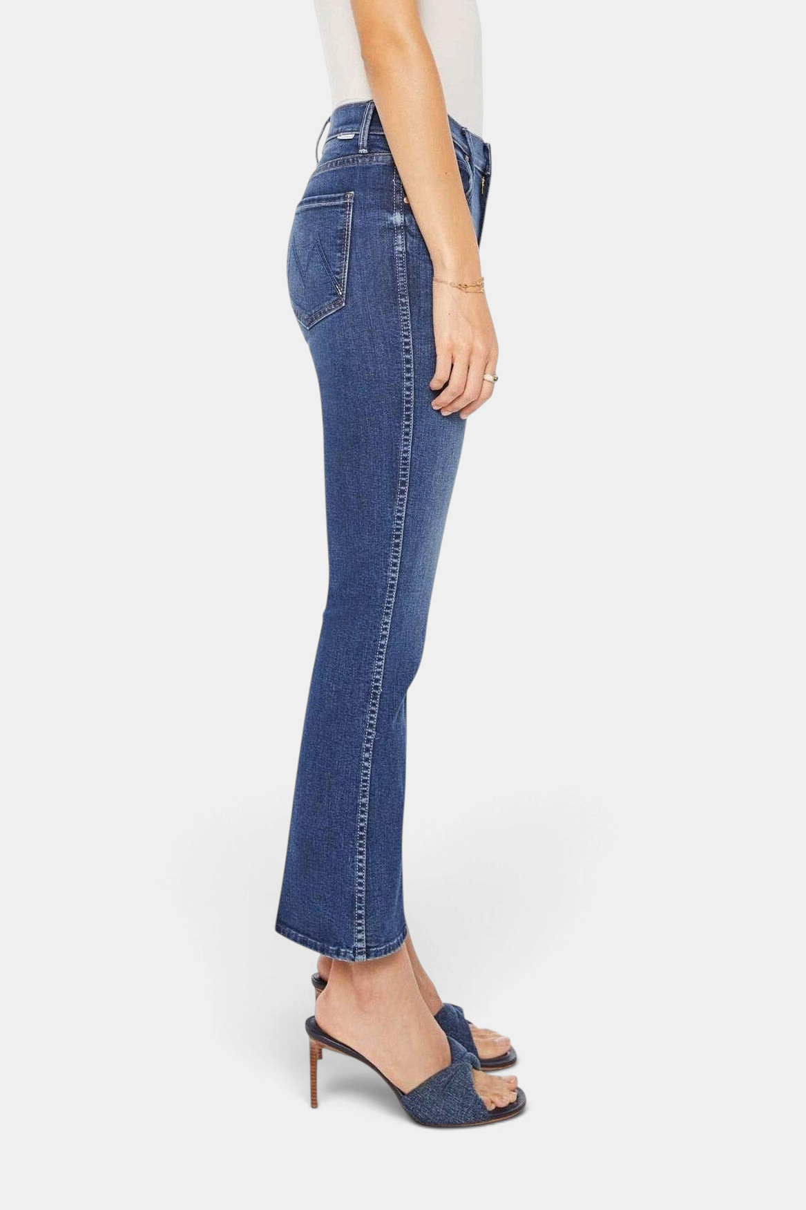 The Copper Shed mid-rise flared jeans in dark blue stretch denim with a clean hem, side profile view.