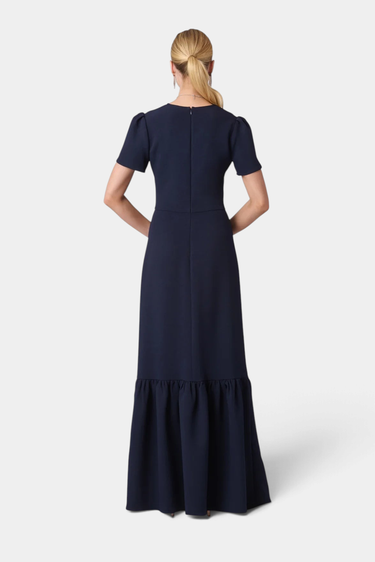 The Copper Shed Midnight Tracy Dress in navy crepe with short pleated sleeves and a flounced hem, back view.