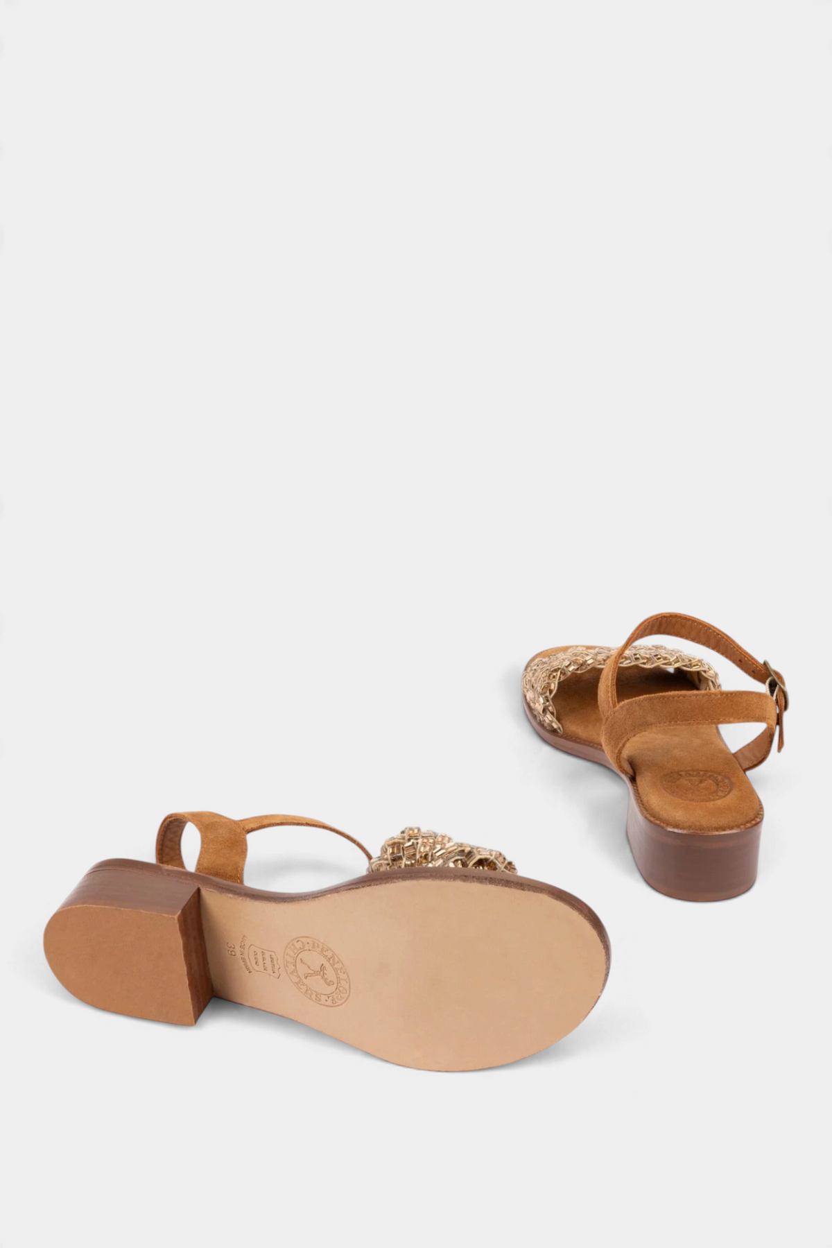 The Copper Shed Milos tan suede sandals featuring a diamante trim and a 3cm leather block heel, shown from below.