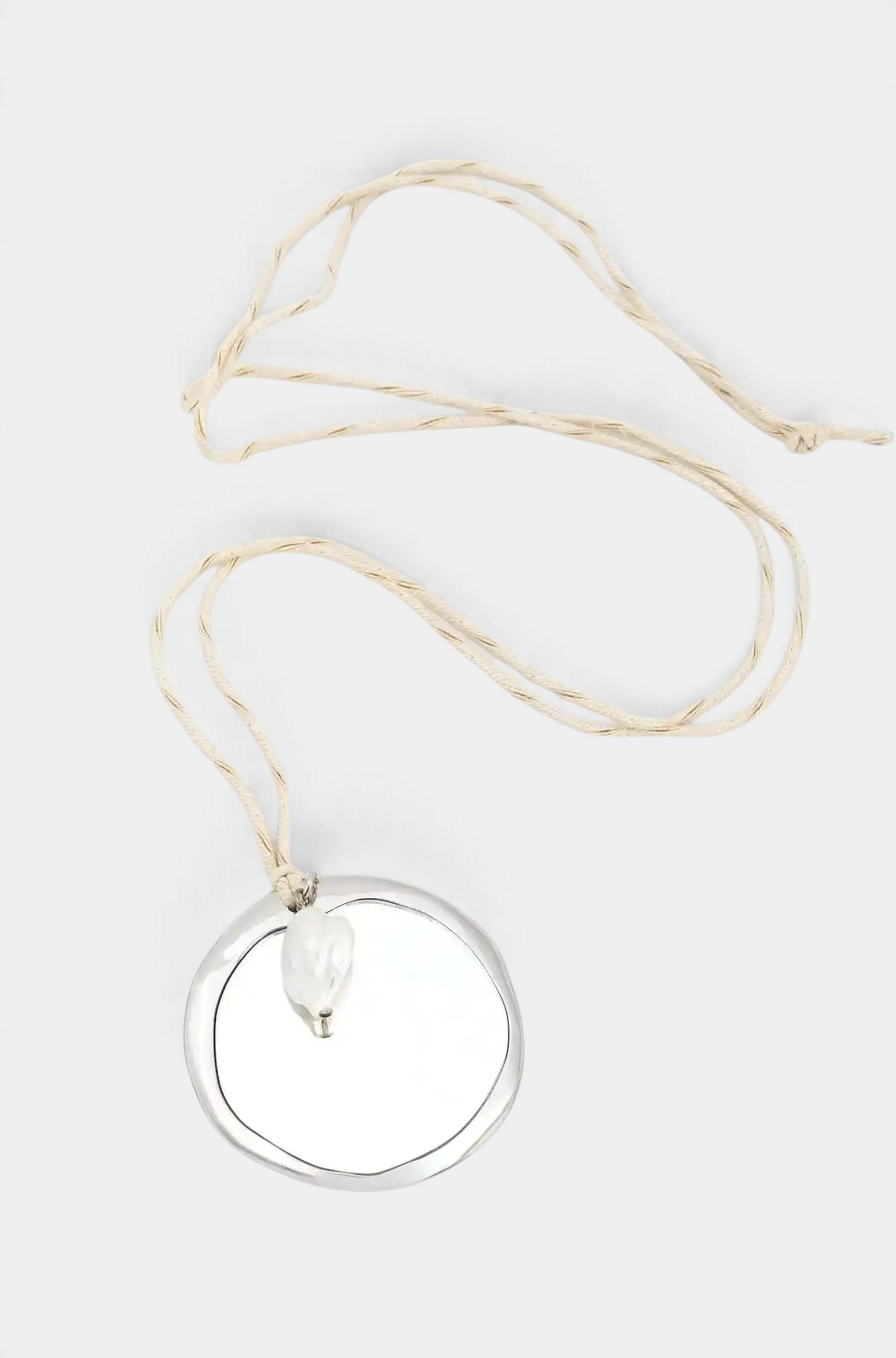 The Copper Shed long necklace featuring a silver zama mirror pendant and a freshwater river pearl on a cotton cord.