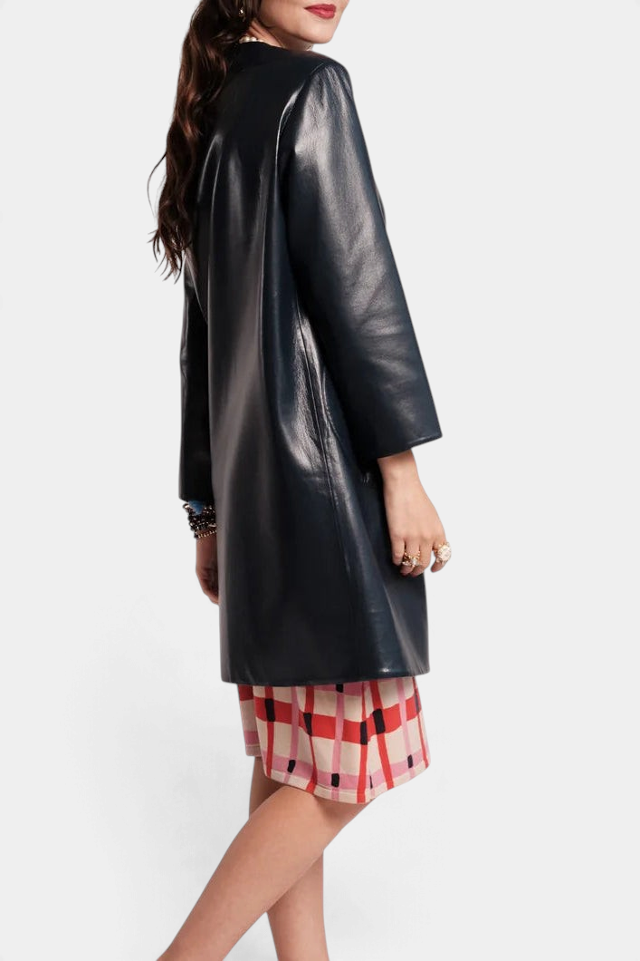 The Copper Shed Mod Jacket in black faux leather, featuring a round collar and sleek car coat silhouette.