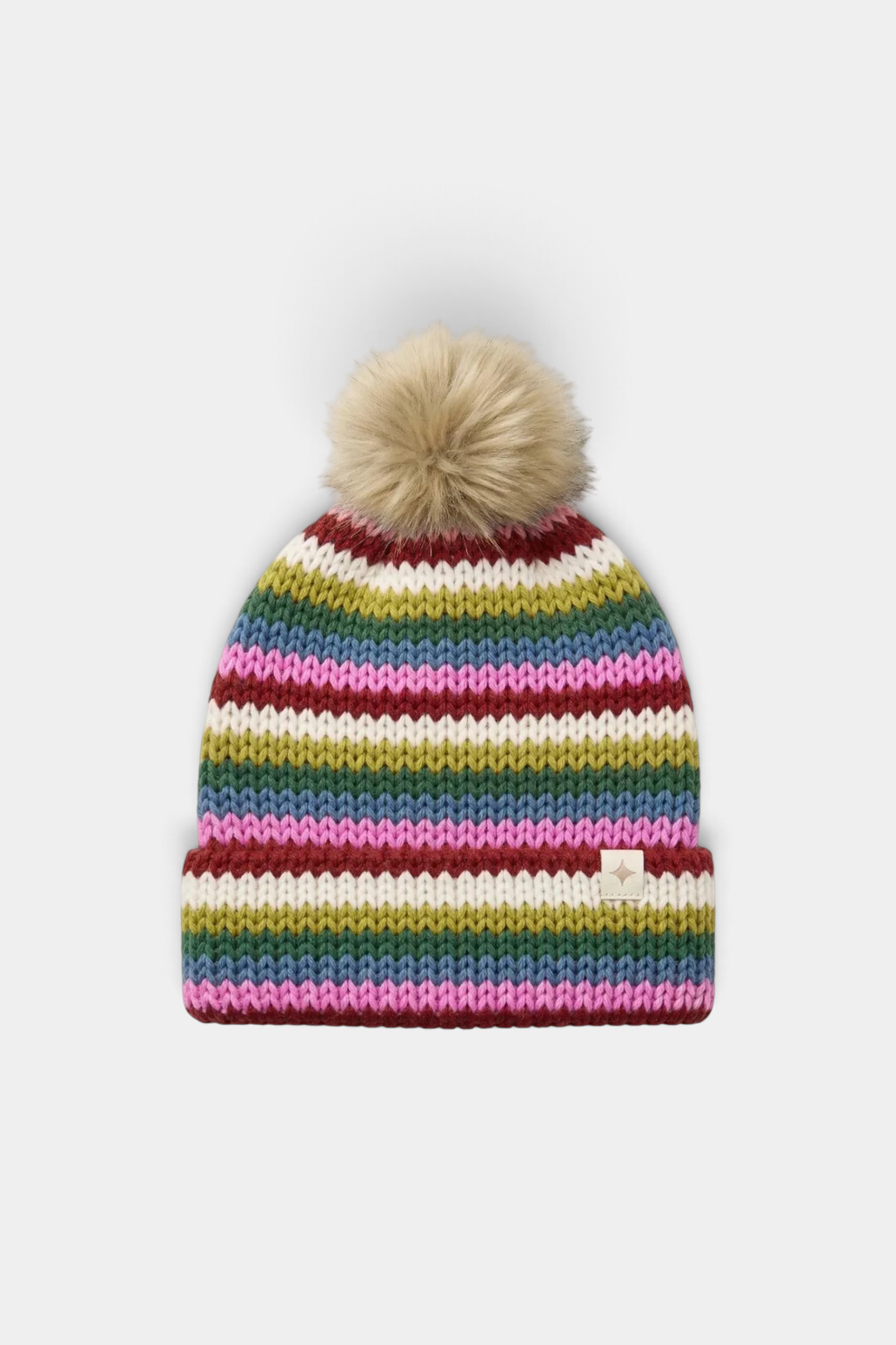 The Copper Shed multi-stripe knit beanie with a faux fur pom-pom and a small branded patch on the cuff.