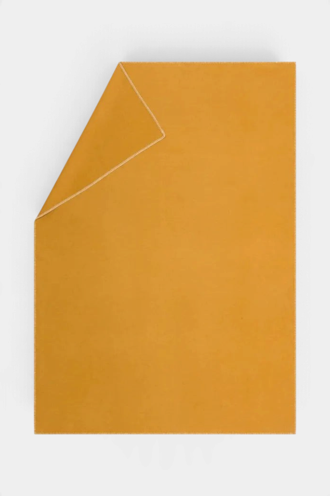 The Copper Shed SYLT mustard yellow recycled cotton blanket with elegant decorative stitch edge