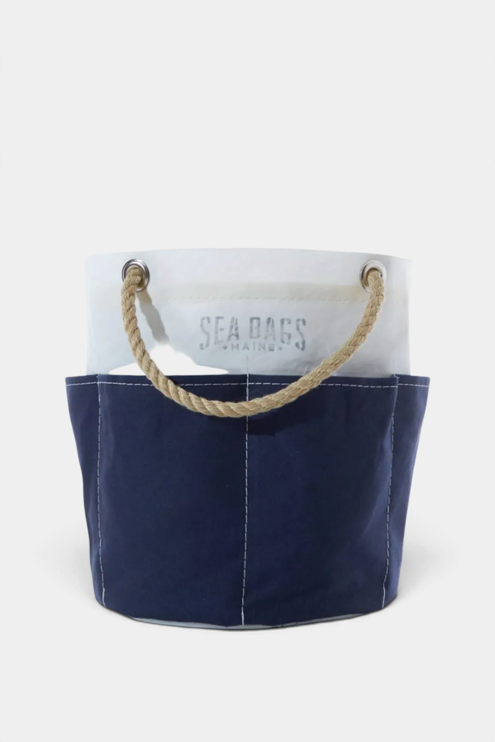 The Copper Shed navy canvas tool bucket bag with white trim and sturdy hemp rope handles for versatile storage.