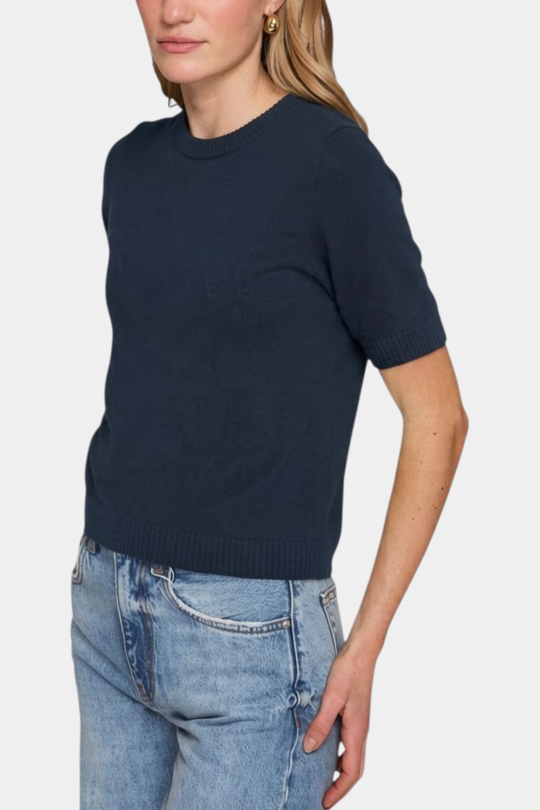 The Copper Shed Autum Cashmere navy blue short sleeve cropped crew neck sweater with ribbed trim on a model