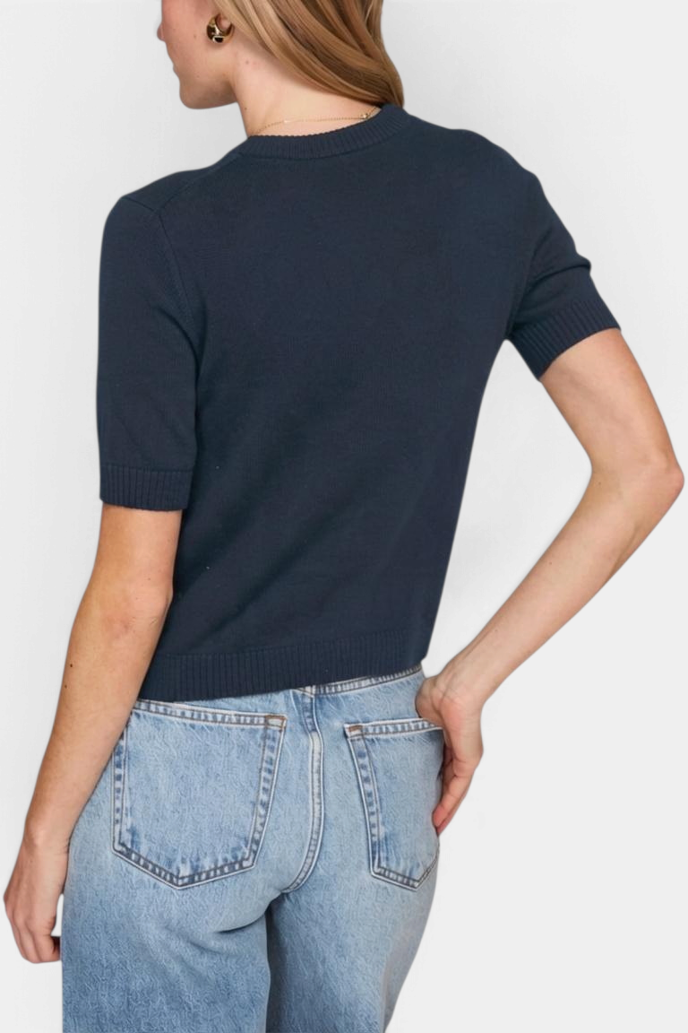 The Copper Shed Autum Cashmere navy short sleeve cropped crew neck sweater with ribbed trim worn with blue jeans